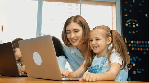 Student use laptop writing code while teacher explain about program. Erudition. Photos