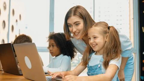 Student use laptop writing code while teacher explain about program. Erudition. Photos