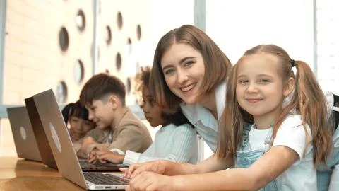 Student use laptop writing code while teacher explain about program. Erudition. Photos