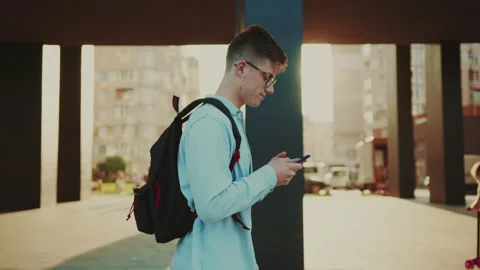 Student use smartphone, browsing internet and scrolling news while walking at Stock Footage 141557166