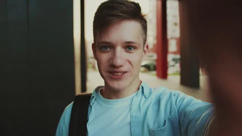Student use video call to speak with his friends. Video portrait of young man in Stock Footage 141558419