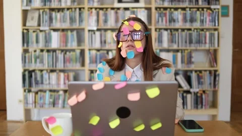 Student uses colorful sticky notes to collect ideas while writing a term paper o Stock Footage 341657156