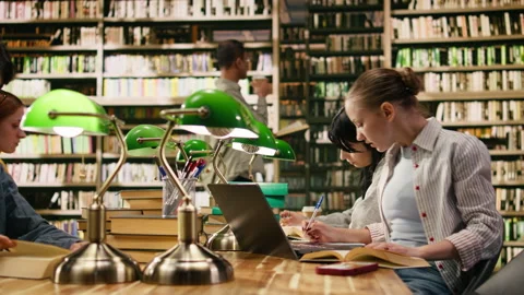 Student uses laptop and book losing concentration when mobile message appears Stock Footage 336358564