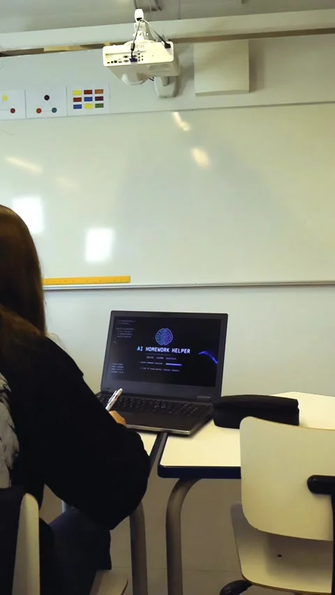 Student using ai homework helper on laptop in classroom Stock Footage 347775390