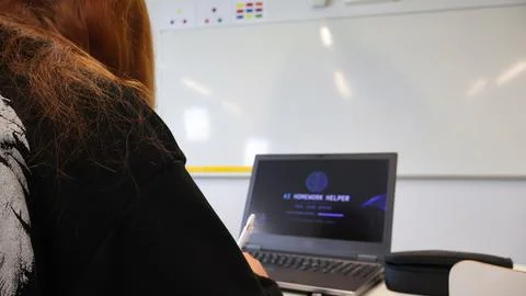 Student using AI homework helper on laptop in classroom Stock Photos