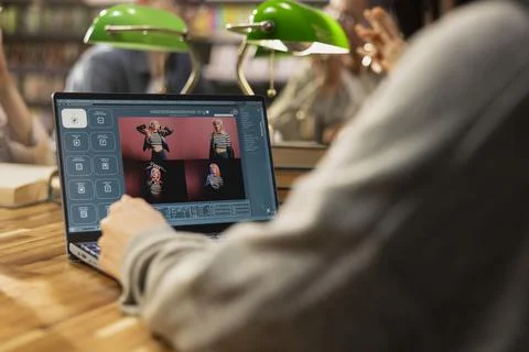 Student using AI image generator on laptop during collaborative study session Stock Photos