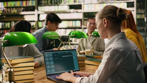 Student using AI study assistant interface on laptop during group study session Stock Footage 336359678
