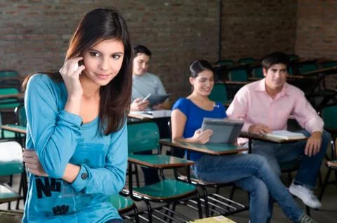 Student using the cellphone on the class Stock Photos