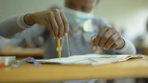 Student using compass in classroom, geometry drawing on paper at school desk Vídeos de archivo 219982987