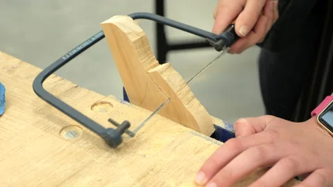 Student Using A Coping Saw To Shape A Piece Of Timber, CLOSE UP Vídeo Stock 142111792