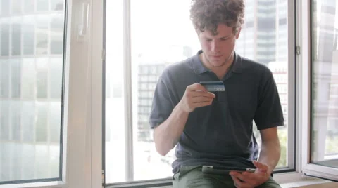 Student using his credit card and tablet Stock Footage 40624695
