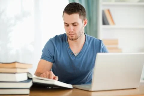 Student using his laptop for his homework Stockfoto's