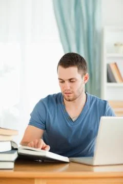 Student using his notebook for his homework Stock Photos
