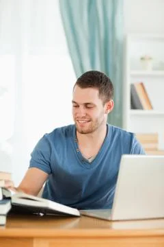 Student using the internet for his book report Stock Photos