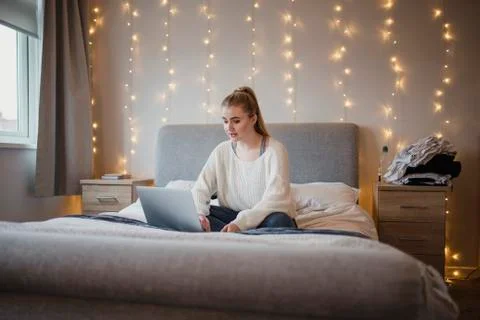 Student Using Laptop in Bedroom Photos