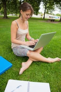 Student using laptop with books at the park Stock Photos