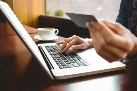 Student using laptop in cafe to shop online Stockfoto's