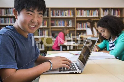 Student Using Laptop In Library