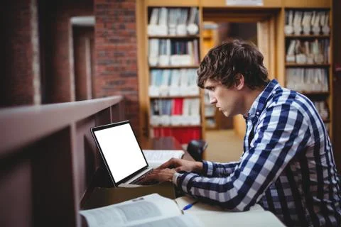 Student using laptop in library 스톡 사진
