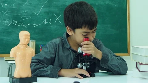 Student using microscope in classroom Stock Footage 105632244