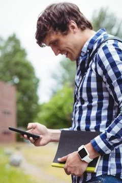 Student using mobile phone in campus Foto stock