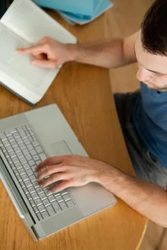 Student using notebook for his homework Stockfoto's