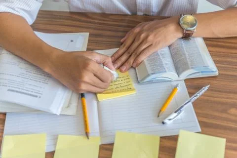 Student using pencil, eraser and sticky notes Stock Photos