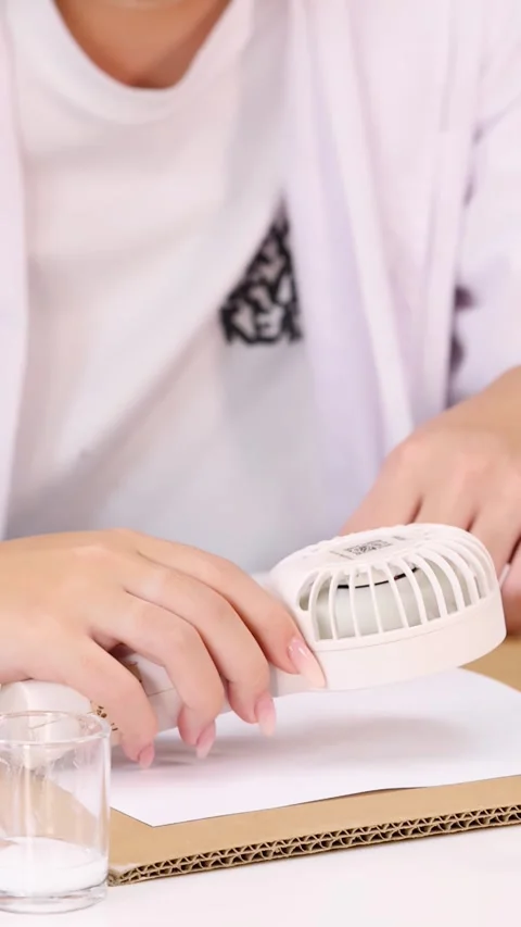 Student Using Portable Fan for Science Experiment in Classroom Stock Footage 345012674
