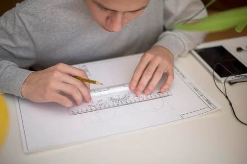 A student using a ruler a t-square draws drawing Stock Photos