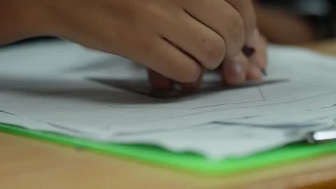Student Using Triangular Scale Ruler to Draw Precise Lines on Lined Notebook Stock Footage 343712774