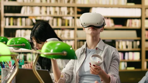 Student using VR device and controller to explore immersive learning Stock Footage 336360564
