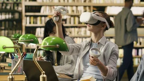 Student using VR device and controller to explore immersive learning Stock Photos