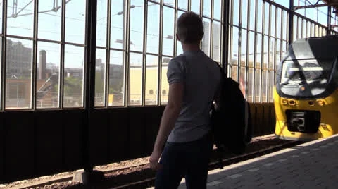 Student waiting for arriving train, steadicam shot Stock Footage 25770025