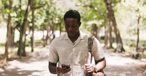 Student, walking and black man in city, cellphone for texting and message to Stock Footage 329601096