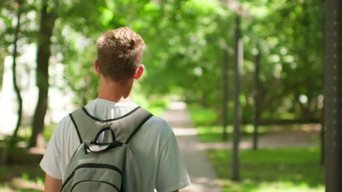 Student walking on university campus. Man walking on his way to college. Yo.. Stock-Footage 339524436