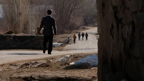 Student walking in the village Stock Footage 294966941