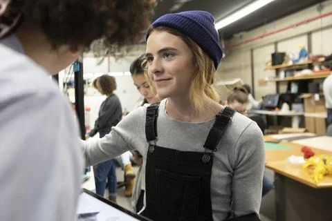 Student wearing hat using 3d printer in college Foto stock