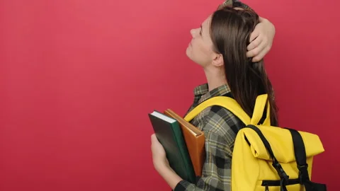 Student woman on back position looking back while scratching head Stock Footage 202887555