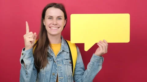 Student woman holding speech bubble make gesture raises finger came up Stock Footage 202896653