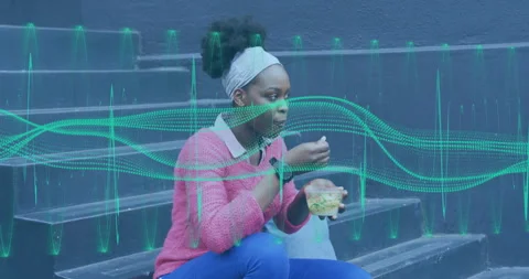 Student woman reaching into clear container and scooping salad with fork during Stock Footage 312004834