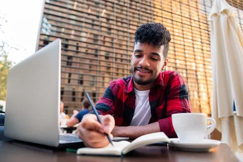 Student working with computer and taking notes 스톡 사진