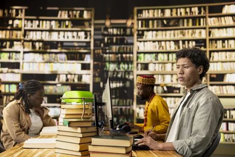 Student working at desktop computers in library learning space Stock Photos