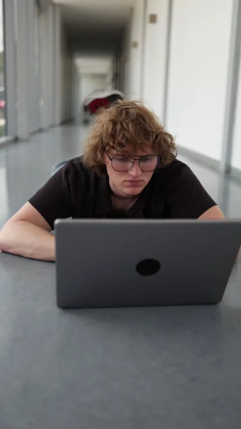 Student working on floor with laptop Stock Footage 337851120