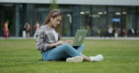 Student working on laptop while sitting in the park. Stock Footage 195274656
