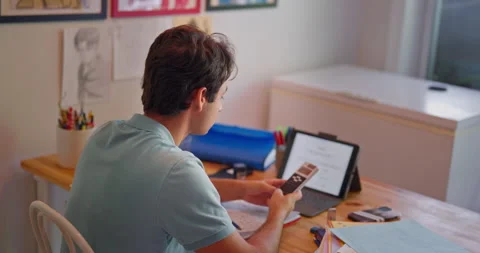 Student working math from back view with calculator and tablet Stock Footage 317078672