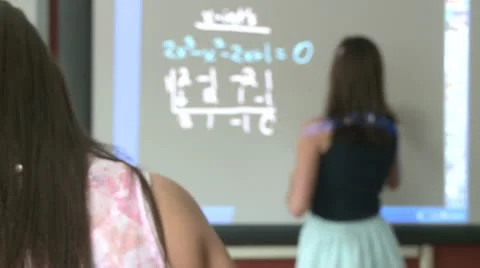 Student working on math problem on board in front of classroom (2 of 2) Vídeos de archivo 10332845