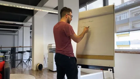 Student working on math task on white board and finding solution at modern Stock Footage 240897848