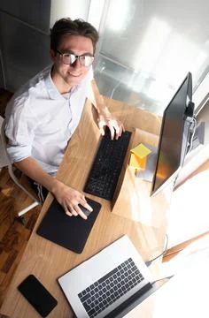 Student working on notebook pc for remote lesson or homework. Smiling with gl Stock Photos