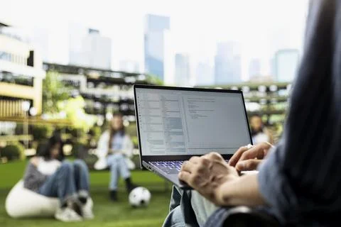 Student working on programming code on laptop during campus study session Foto stock