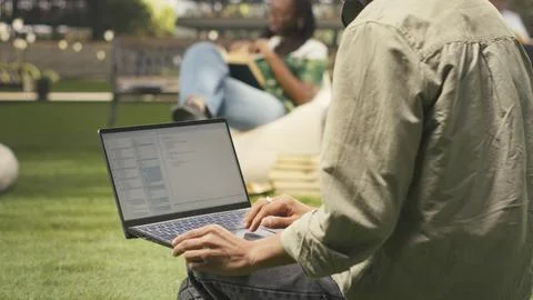 Student working on programming code on laptop during study session Stock Photos